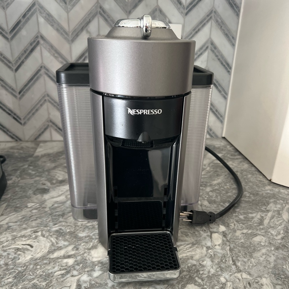 Nespresso machine with frother and pod holder